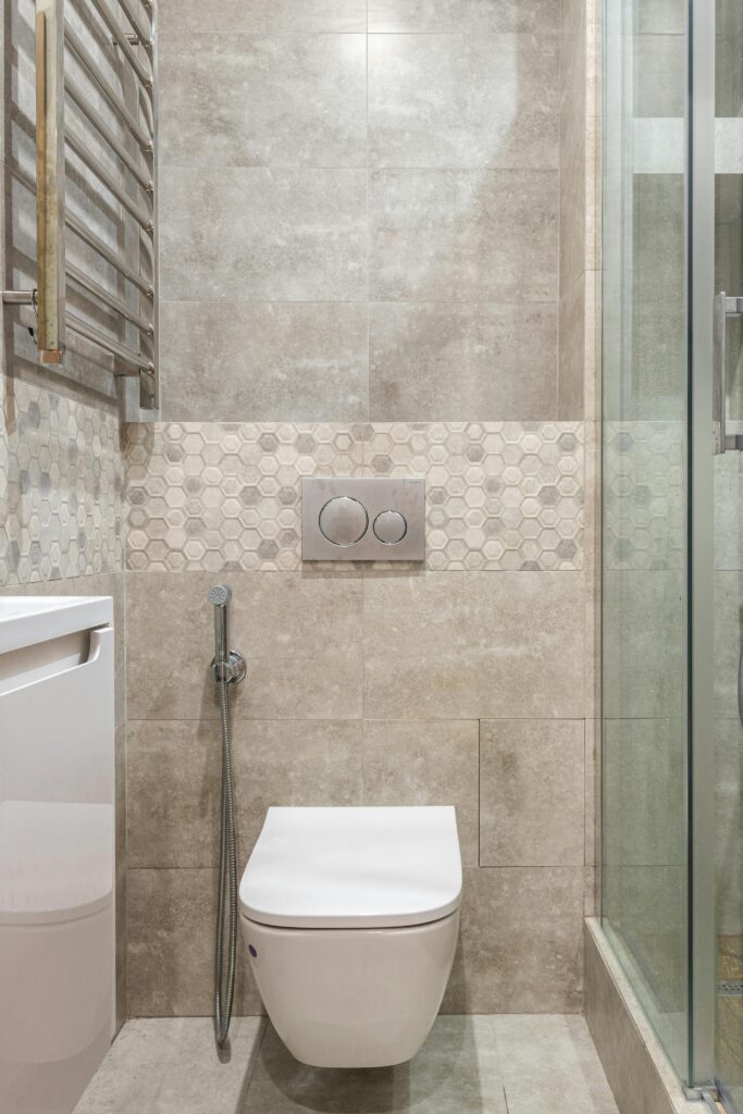 Contemporary bathroom design featuring a wall-mounted toilet, bidet, and glass shower.